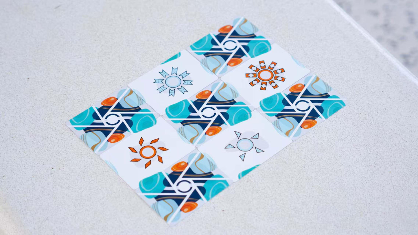 Colorful geometric card backs and trick cards on a light gray surface