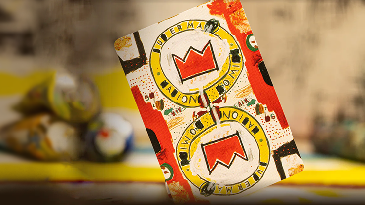 Card Back featuring a Basquiat painting, placed on a table with various paint tubes.