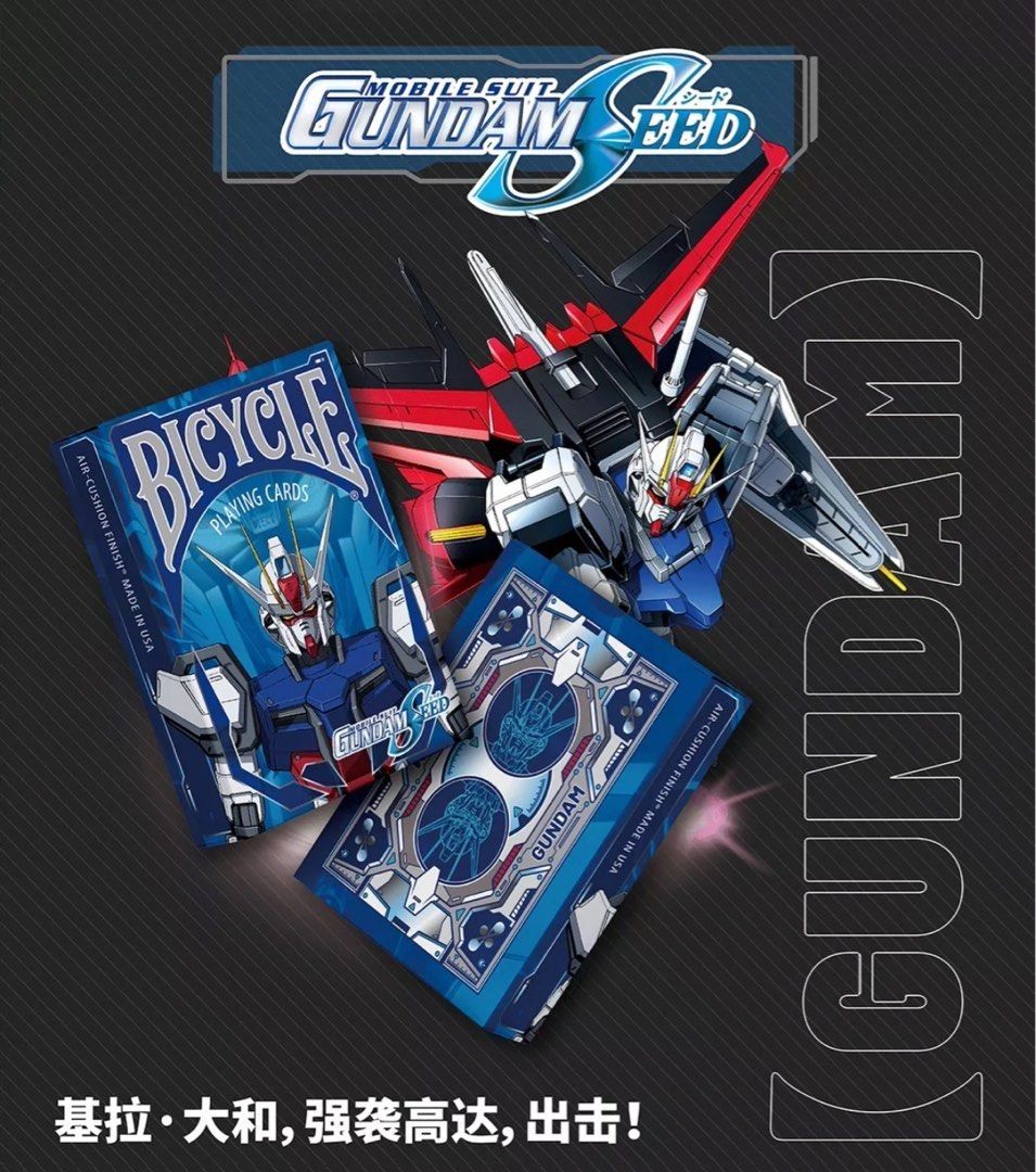 A promotional image for Bicycle Gundam Seed playing cards featuring anime-style character designs on the cards and a large poster of a mecha robot from the series.